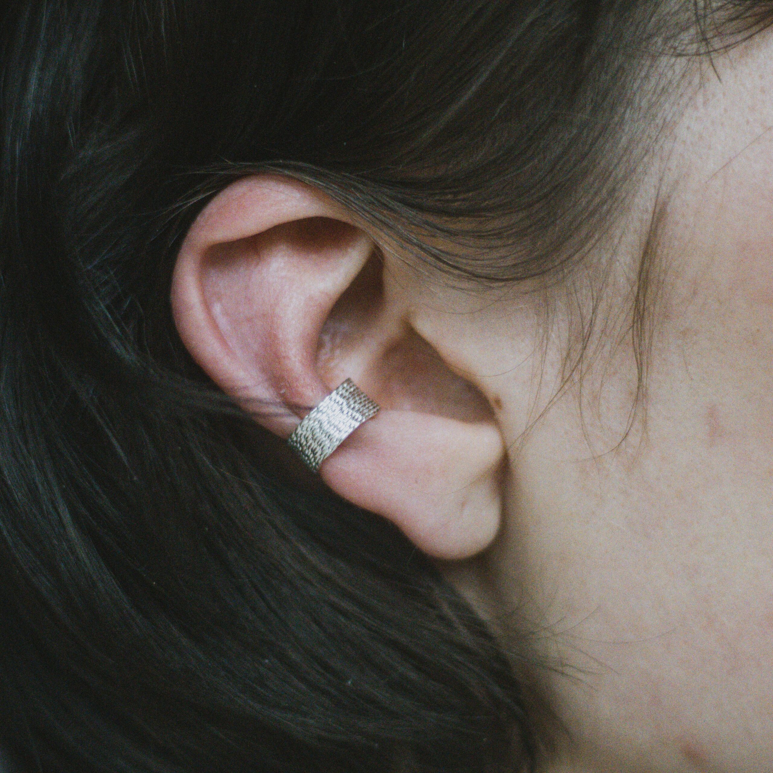 Handmade filigree ear cuff in sterling silver on the ear